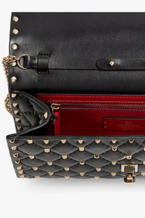 Valentino women’s black quilted leather rockstud spike crossbody bag with gold-tone studs and red interior lining