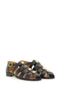 Valentino women’s black leather fisherman’s sandal with gold tone circular studs and vlogo signature buckle