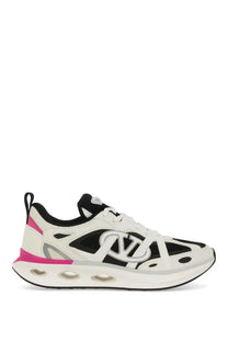 Valentino women’s white and black athletic sneaker with pink accents and bold vlogo logo on the side