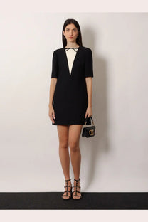 Black leather valentino handbag with gold-tone hardware and logo clasp paired with valentino women’s virgin wool silk mini dress black