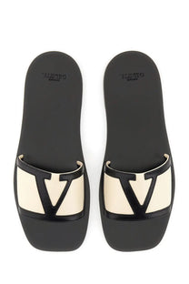 Valentino women’s Viva Superstar slide sandal in white nappa leather with black and cream slides and glossy black V logo