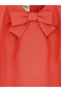 Valentino women’s wool and silk blend short dress in coral with a prominent bow at the neckline