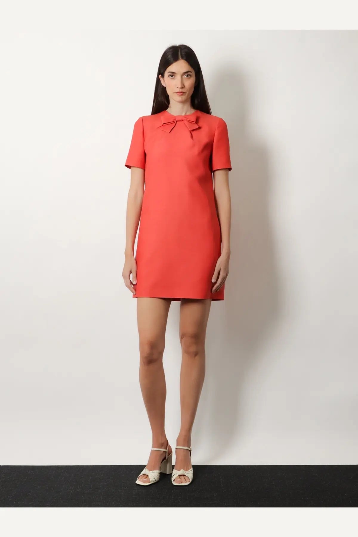 Valentino women’s coral wool and silk blend short dress with structured bodice and bow neckline detail