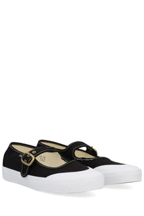 Black canvas Vans unisex mary jane shoe with white rubber soles and gold-tone buckle straps