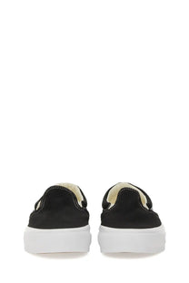 Vans unisex slip on premium sneaker in black canvas with white rubber sole and cream-colored lining