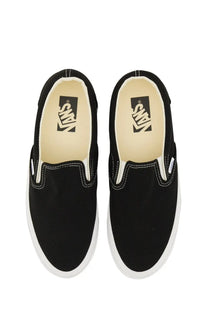Black vans unisex slip on premium sneaker featuring black slip-on canvas with white rubber soles and contrasting stitching