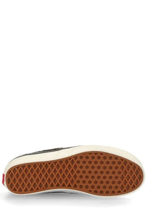 Black and white vans unisex sneaker authentic pattern slip-on with brown rubber sole and diamond tread pattern