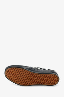 Vans women’s lx authentic fabric sneakers in black feature a black and white checkerboard slip-on design with tan sole