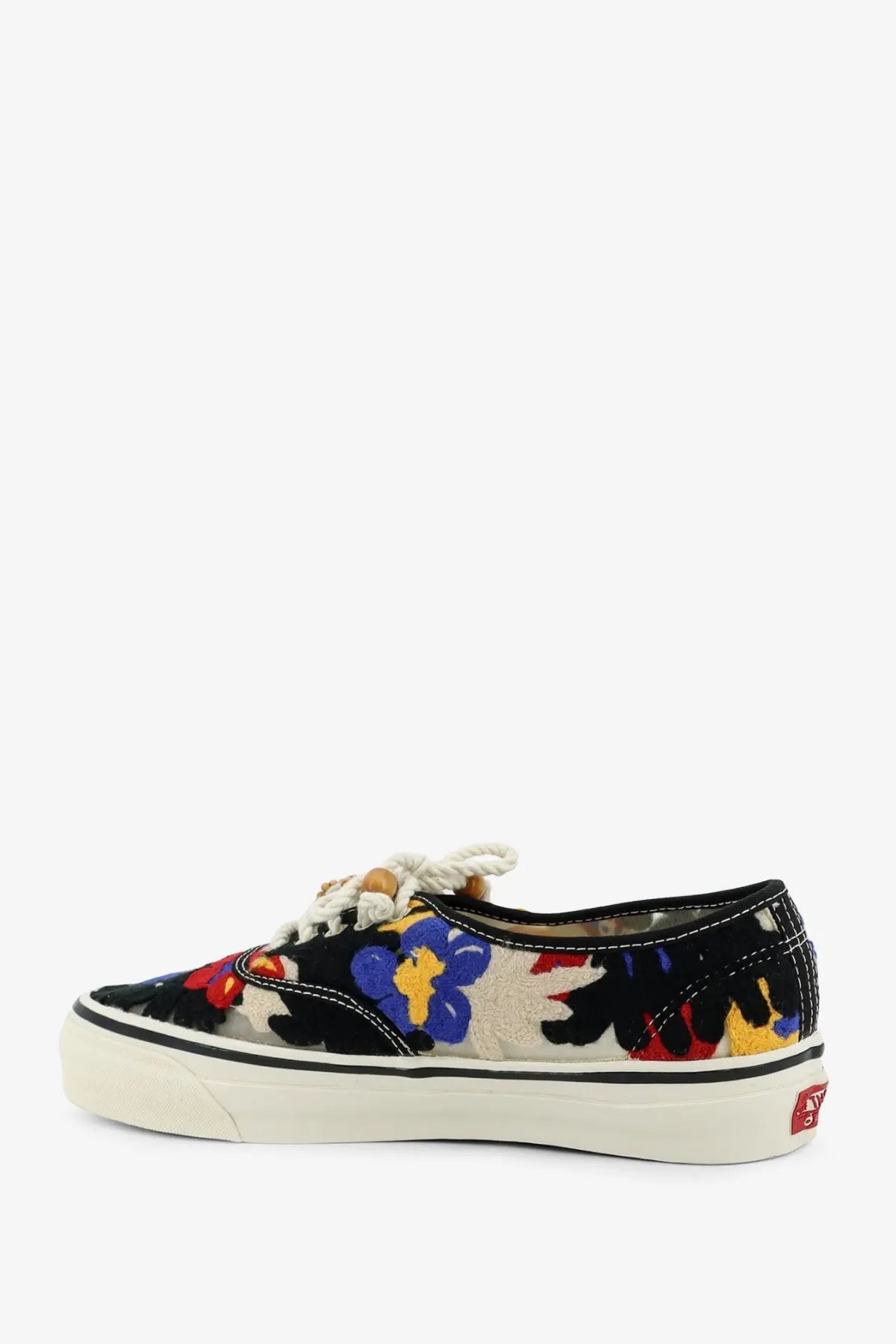 Vans women’s lx authentic sneakers black canvas low top with vibrant red blue yellow floral embroidery on cream background
