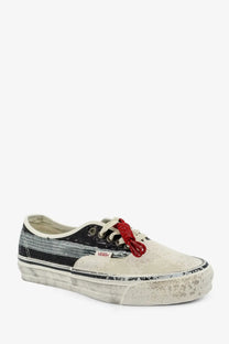 Distressed off-white vans women’s lx authentic suede sneaker with black silver stripe red laces and worn rubber sole