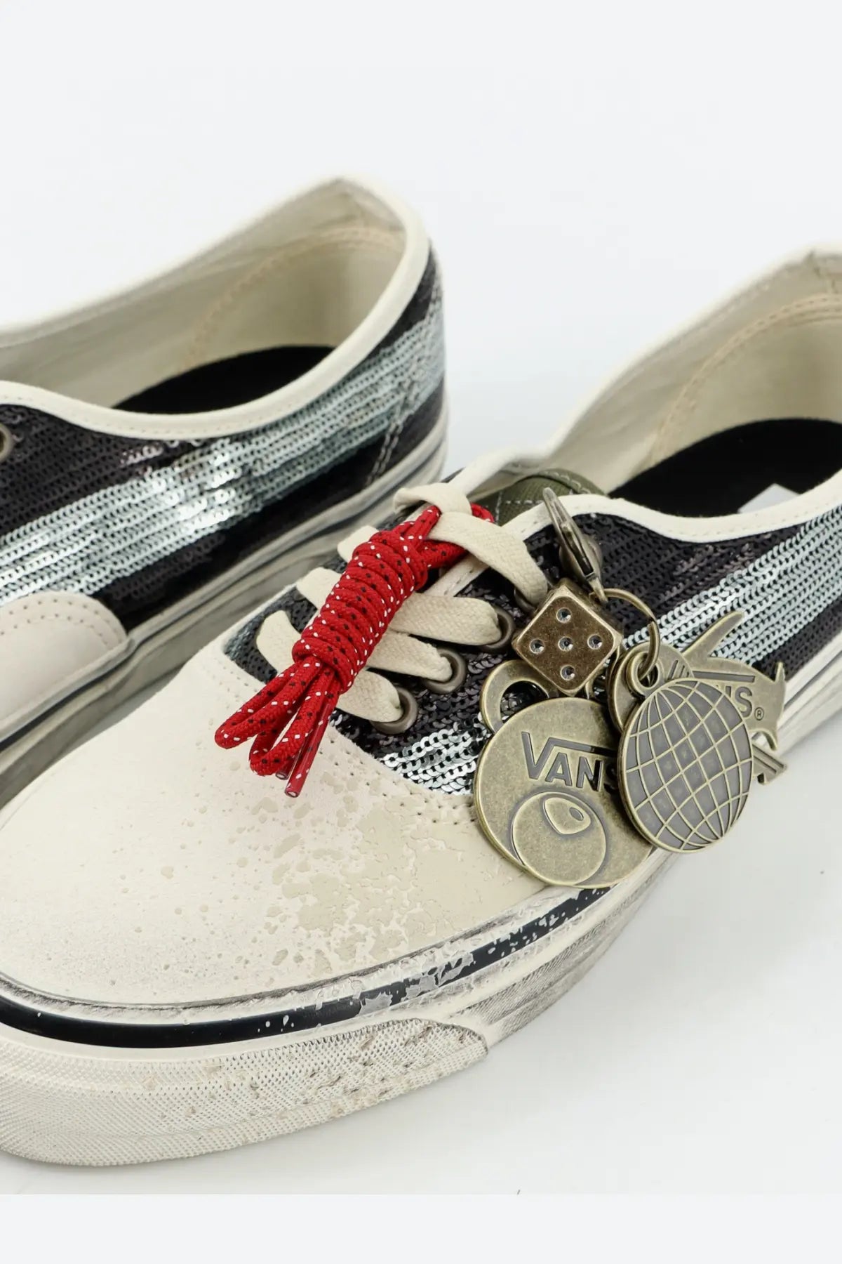White and silver sequined vans slip-on sneakers with red braided laces and metallic charms for women