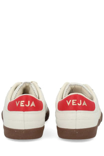 Veja men’s panenka sneaker in cream leather with a bold red heel tab featuring gold logo and brown rubber soles back view
