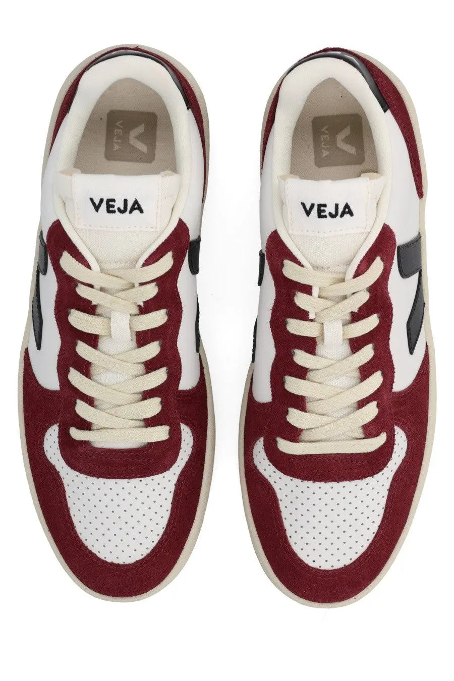 Maroon and white suede sneakers with perforated toe panels, black side stripes, and cream laces.