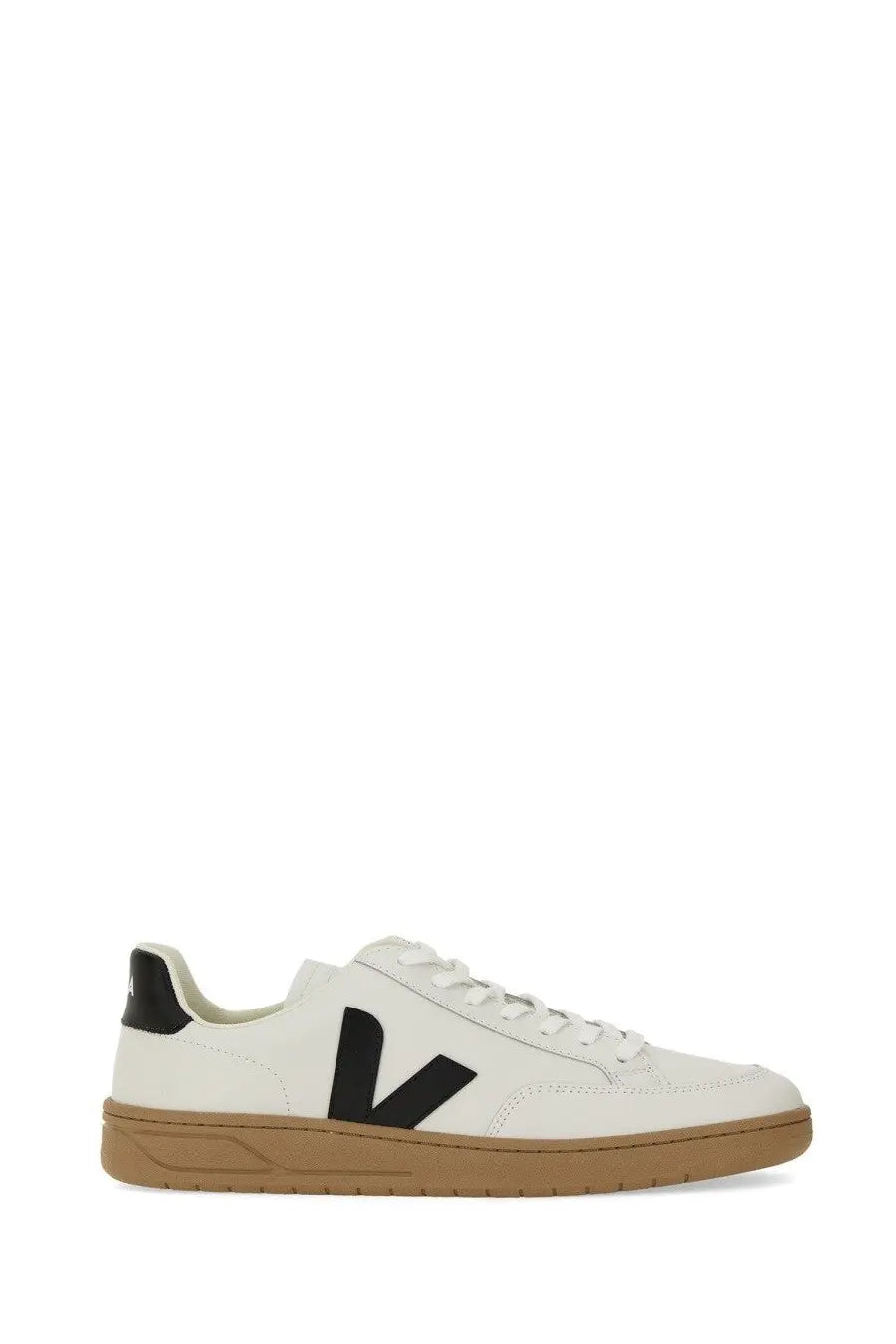 Veja men’s white leather sneaker with bold black V logo, tan rubber sole, and black heel tab