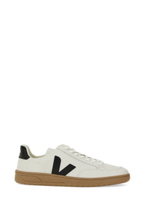 Veja men’s white leather sneaker featuring a bold black V logo and tan rubber sole for casual wear