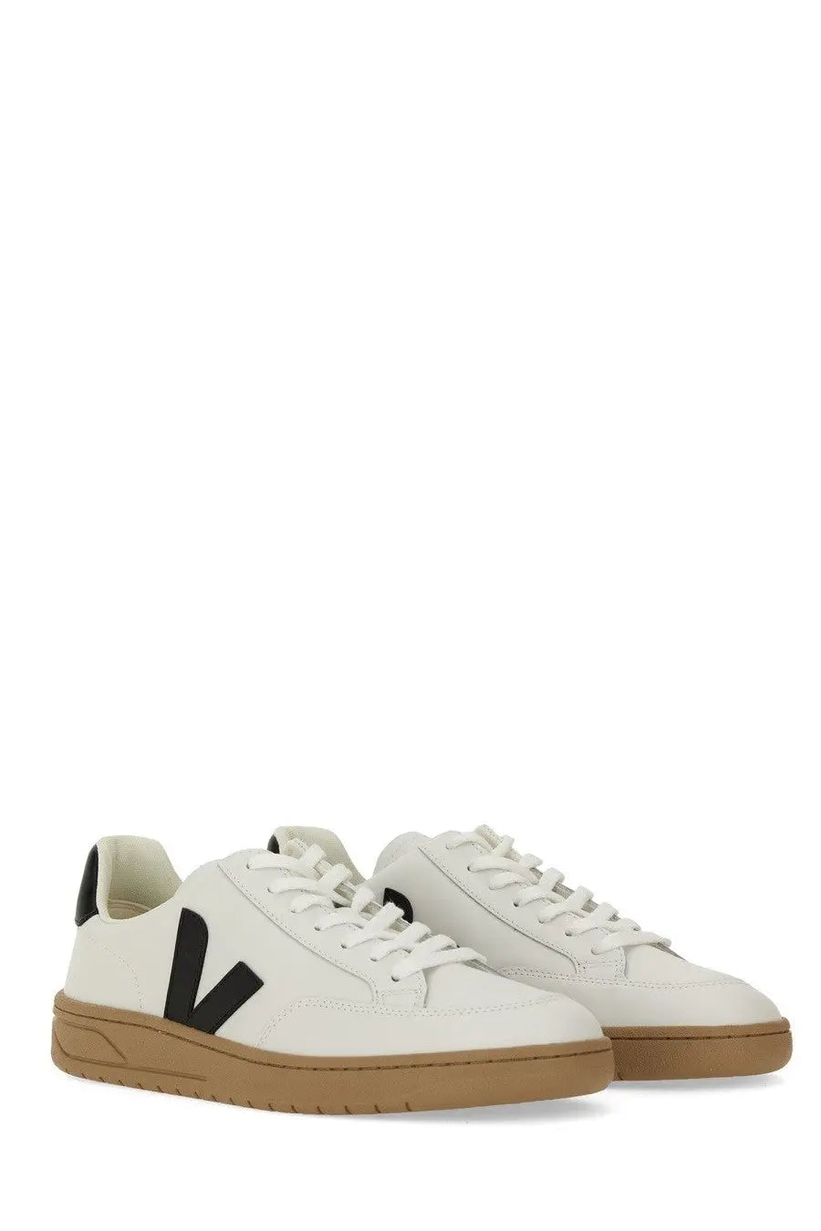 Veja men’s sneaker white leather with bold black v logo and tan rubber soles for casual wear