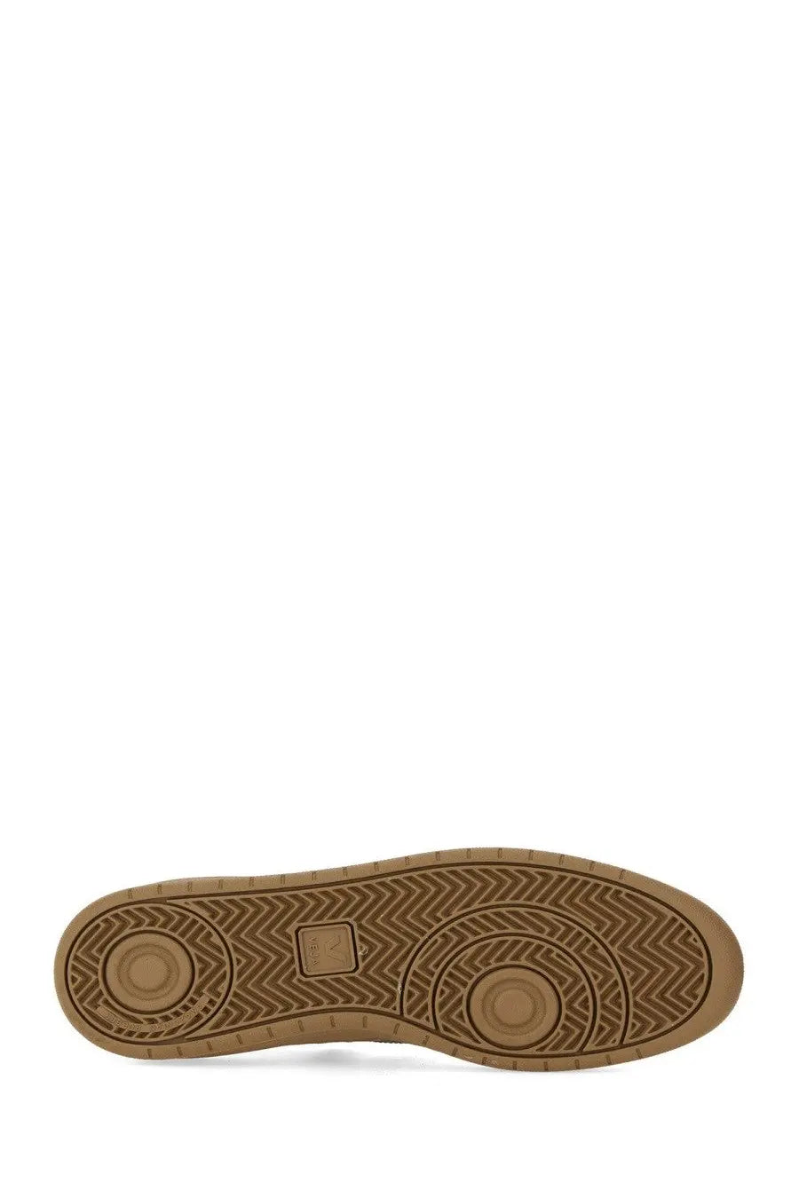 Tan rubber sole with herringbone tread and circular wear indicators on veja men’s sneaker white