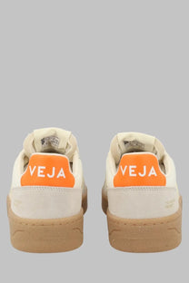 Veja unisex sneaker beige cream-colored suede with vibrant orange heel tab featuring veja logo in white on back side