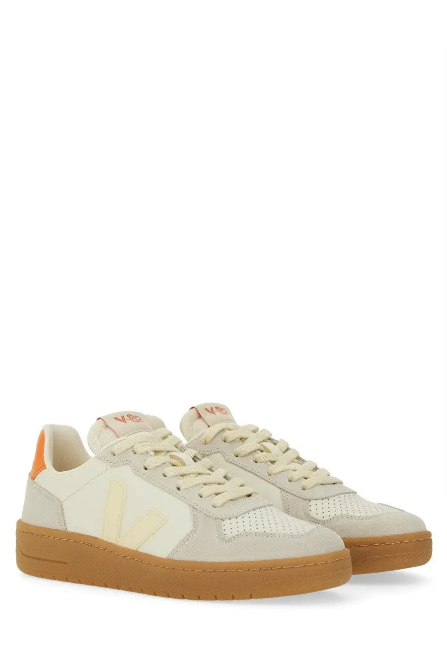 Veja unisex sneaker in cream-colored suede and mesh with tan rubber sole and orange heel tab visible from the back