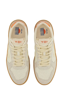 Cream-colored Veja unisex sneaker v-eja v-82 with perforated toe panels and orange accents on the heel tab