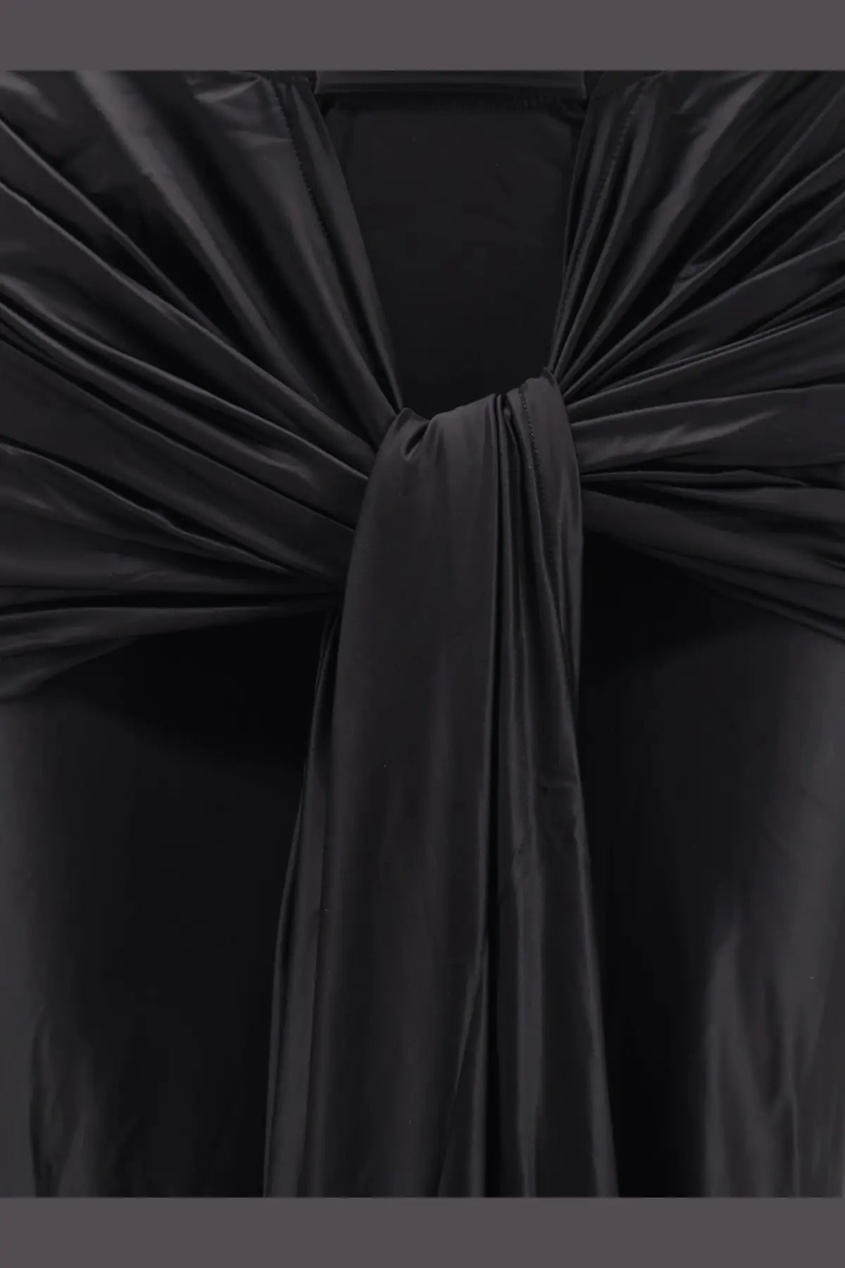 Black satin decorative knot detail on the venuja women’s shiny microfiber skirt in black