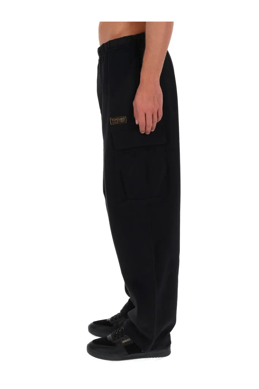 Black Versace Jeans Couture men’s cargo jogger pants featuring a gold-tone rectangular patch on the thigh pocket