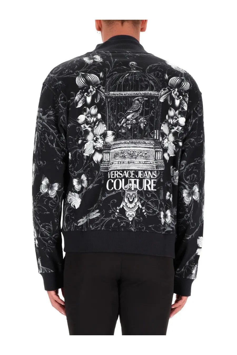 Back view of versace jeans couture men’s black cotton fleece bomber jacket with white floral and birdcage print