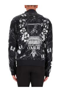 Back view of versace jeans couture men’s black cotton fleece bomber jacket with white floral and birdcage print