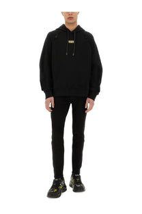 Versace Jeans Couture men’s black hooded sweatshirt with gold-tone logo patch and contrasting black drawstrings