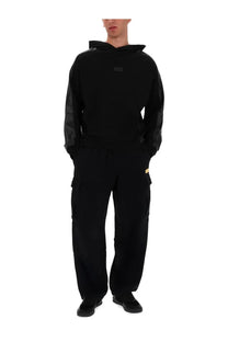 Versace Jeans Couture men’s black hoodie with sheer mesh sleeves and small rectangular logo patch on chest