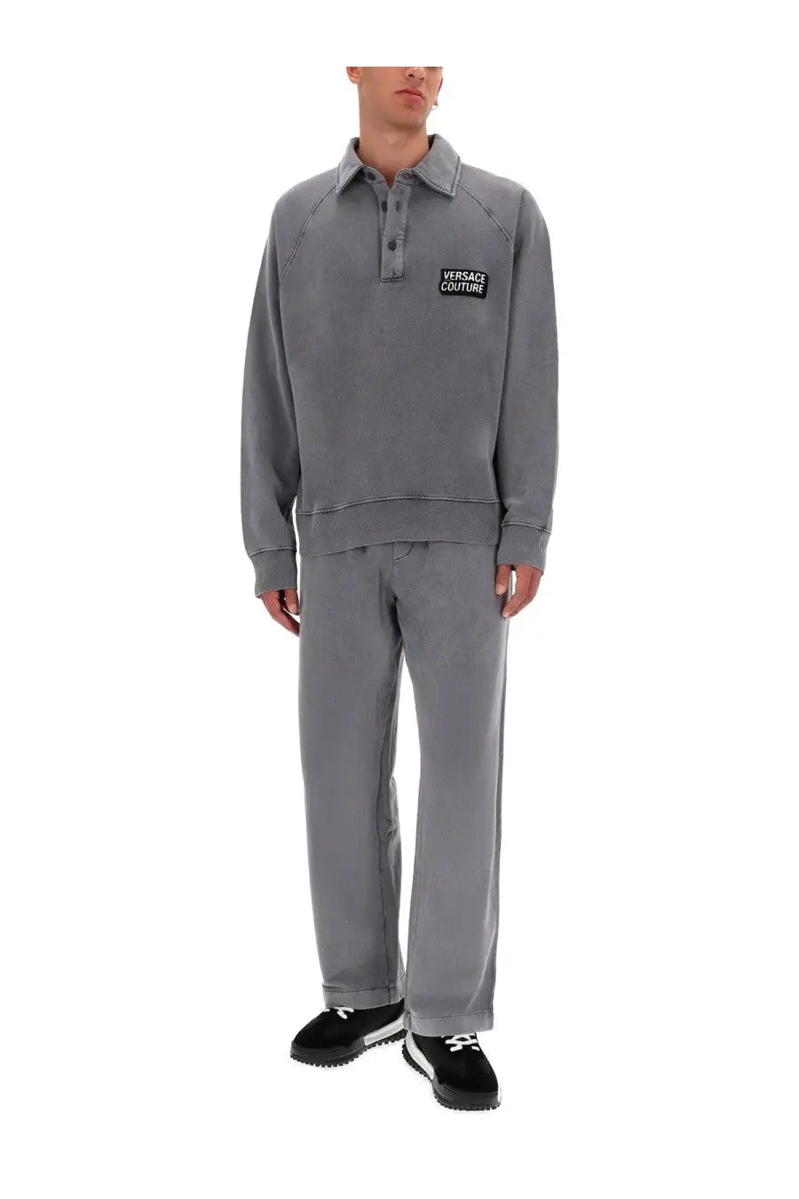 Gray versace couture polo sweatshirt with black embroidered logo patch on chest paired with mens jogger pants gray