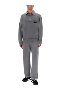 Gray versace couture polo sweatshirt with black embroidered logo patch on chest paired with mens jogger pants gray