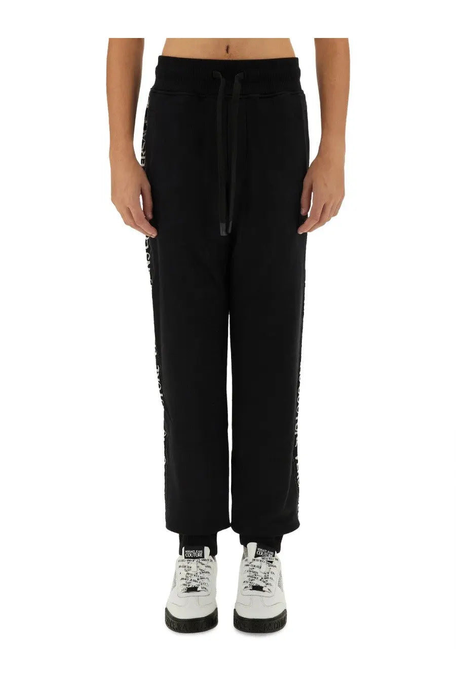 Versace Jeans Couture men’s black joggers with white vertical lettering and matching drawstring waistband