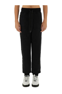Versace Jeans Couture men’s black joggers with white vertical lettering and matching drawstring waistband