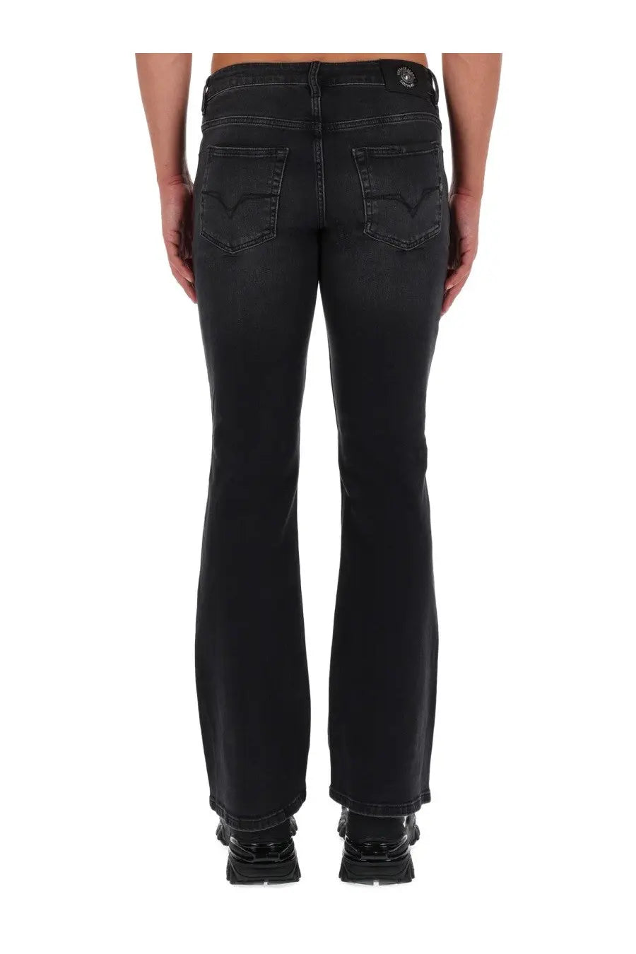 Versace jeans couture men’s black denim flare jeans with subtle distressed finish and back logo patch shown from behind