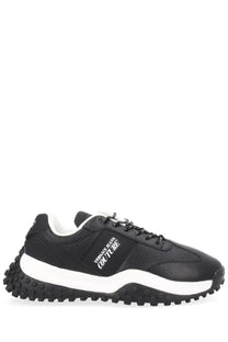 Versace Jeans Couture men’s sneaker con black with textured upper, white midsole, and chunky black rubber outsole