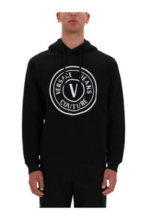 Black versace jeans couture men’s sweatshirt featuring a bold white circular logo with the brand’s signature v and text