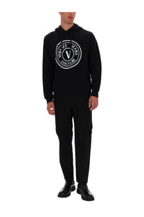 Versace jeans couture men’s black hoodie with bold white circular logo and signature v emblem on front