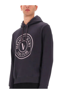 Versace Jeans Couture men’s grey hoodie with dark gray fabric and a light pink and white circular logo on the front