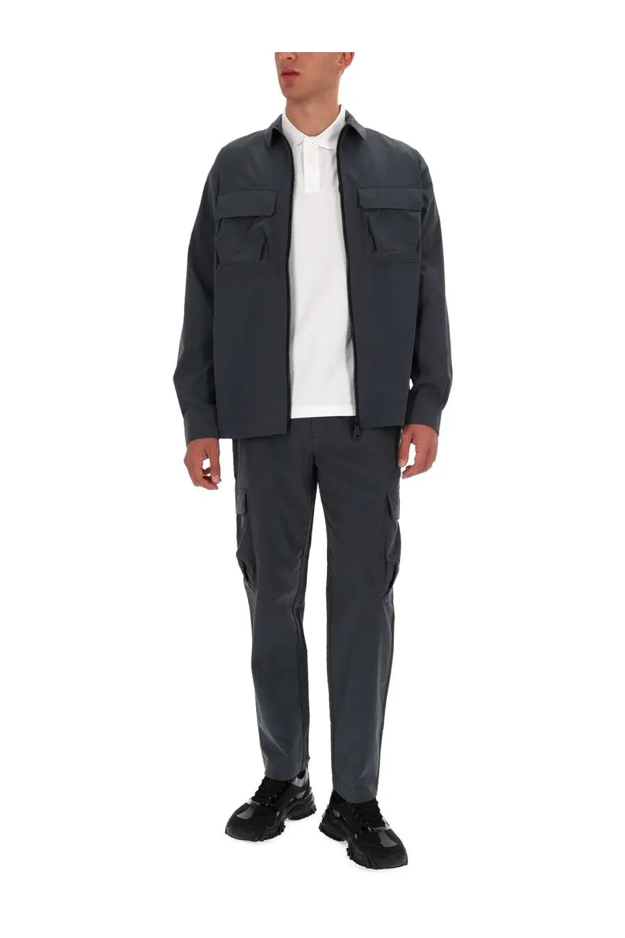 Versace jeans couture men zippered dark gray utility jacket with two chest pockets worn over white polo shirt
