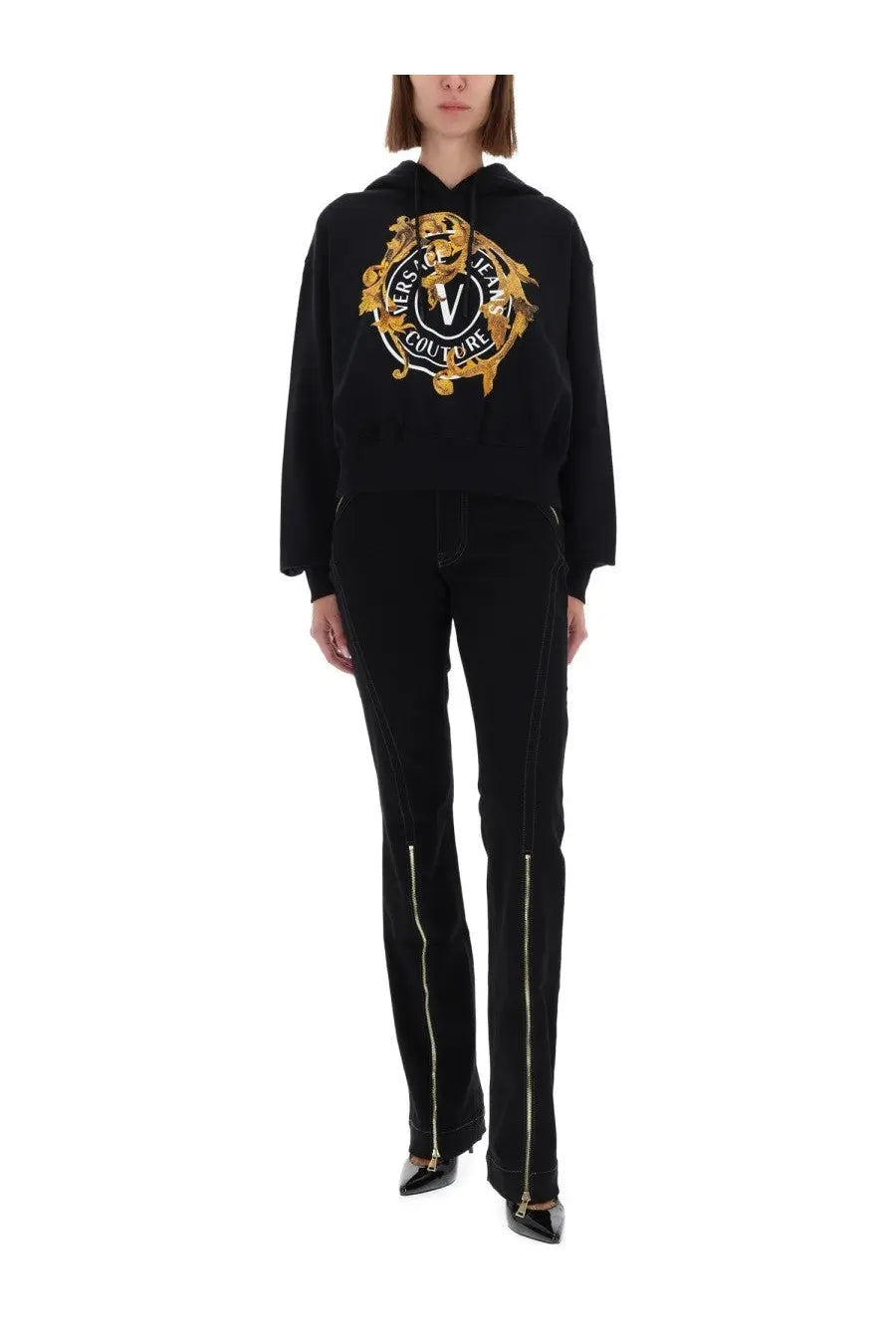 Versace Jeans Couture women’s black hoodie with bold gold embroidered logo and matching side zippers on jeans pants