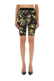 Versace jeans couture women’s black bike shorts with bold gold and white ornate baroque pattern on front side