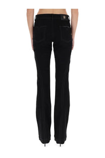Black denim jeans for women with contrasting stitching and branded patch at waistband by versace jeans couture