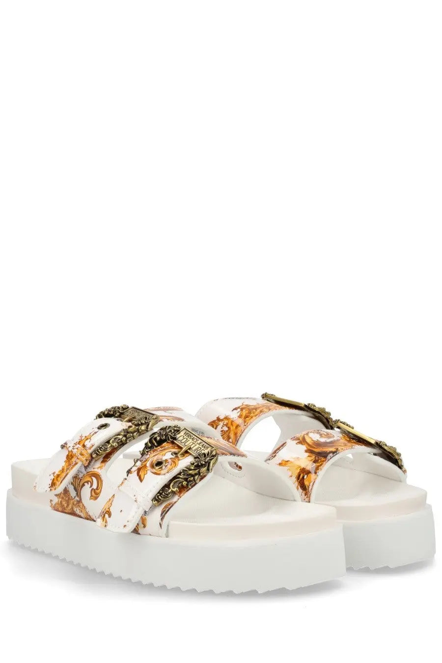 White platform sandals by Versace Jeans Couture featuring a gold and brown baroque pattern with metallic buckles