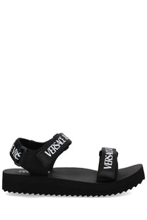 Versace Jeans Couture women’s black sandal with bold white logo straps and chunky platform sole