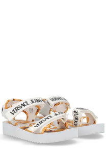 Versace Jeans Couture women’s white platform sandals with bold gold and black logo print on straps