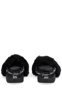 Versace jeans couture women’s black furry slide sandals with glossy rubber sole and white cursive branding on the heel back