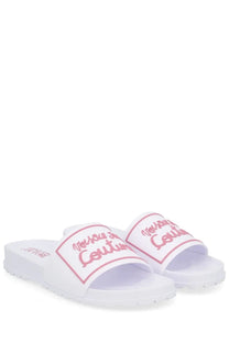 Versace Jeans Couture women’s white slide sandals with pink cursive logo detailing and cushioned sole
