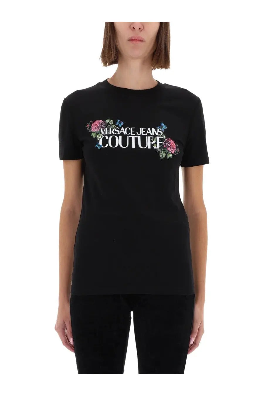 Versace jeans couture women’s black t-shirt with bold white logo and pink blue floral embellishments on front