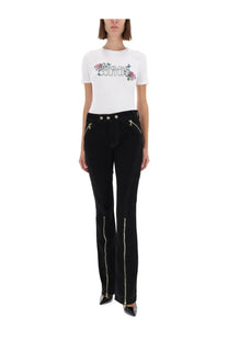Black velvet flare pants with gold zippers down outer legs and front pockets from versace jeans couture women’s shirt white